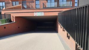 a tunnel with a building with a fence at Old Town Nadmotławie - Sauna & Gym I 10min deptak in Gdańsk