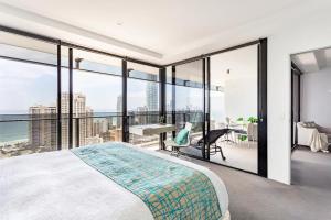 a bedroom with a bed and a view of the ocean at Sealuxe - Surfers Paradise Central -- Ocean View Deluxe Residences in Gold Coast