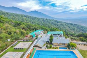 an aerial view of a resort with a swimming pool at Regenta Resort Exotica Dharamshala on Hilltop in Dharamshala