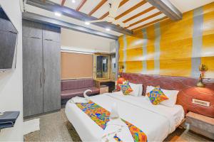 a room with two beds and a tv at FabExpress Prime Middleton in Bhubaneshwar