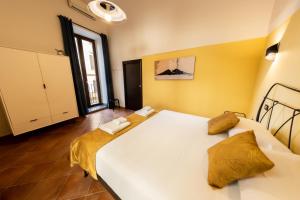 a bedroom with a large white bed in a room at Sebeto Duomo in Naples
