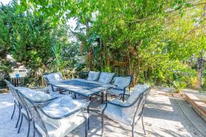 d'une table de patio et de chaises avec des arbres en arrière-plan. dans l'établissement Single Level House with view and pool, à Glendora