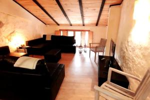 a living room with a couch and a table and chairs at La Casirria in Olba