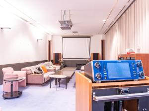 a living room with a tv and a couch at Tabist Yabuki Golf Club in Yabuki
