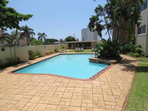 a large blue swimming pool in a yard at Sealodge 75 Umhlanga Durban in Durban