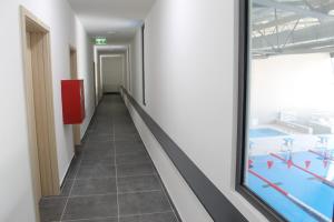 a corridor in a building with a swimming pool at Wellness hotel Mestská plaváreň in Trebišov