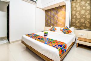 A bed or beds in a room at FabExpress Marvel Bliss Viman Nagar