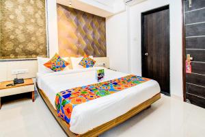 A bed or beds in a room at FabExpress Marvel Bliss Viman Nagar