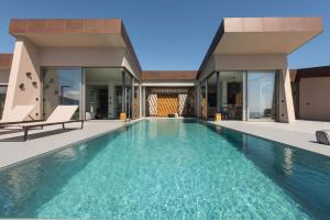 a swimming pool in the backyard of a house at EGO Villas Lefkada in Évyiros