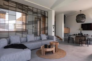 a living room with a couch and a table at Gaia and Thalatta Villas in Évyiros