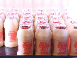 a row of bottles of milk on a shelf at Dormy Inn Takasaki in Takasaki +18 photos