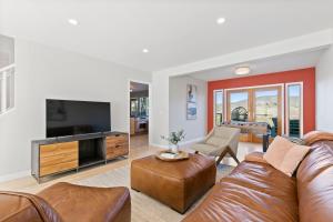 a living room with a couch and a television at @ Marbella Lane - Hidden Gem in Pacifica! in Pacifica