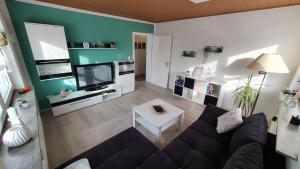 a living room with a couch and a tv at Fewo Am Tiefen Weg in Karlstadt
