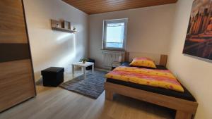 a small bedroom with a bed and a window at Fewo Am Tiefen Weg in Karlstadt