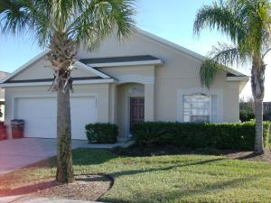 a house with two palm trees in front of it at 4 Bedroom Value Plus Home with Private Pool in Orlando