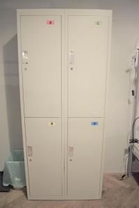 two white storage cabinets in a room at GLOBE Hostel Prague ADULTS ONLY in Prague
