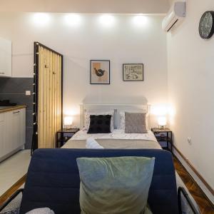 a bedroom with a large bed and two tables at STUDIO MG in Zagreb