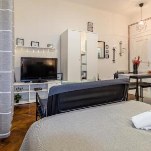 a living room with a flat screen tv and a table at STUDIO MG in Zagreb