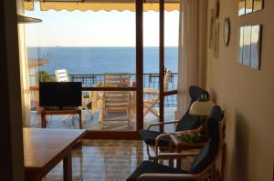 a living room with a view of the ocean at Rocce di Capo Mimosa - Cervo in Cervo