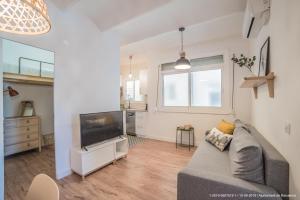 a living room with a couch and a flat screen tv at Poblenou 3bd 5 min to the Beach in Barcelona