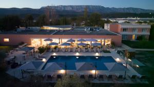 an aerial view of a resort with a swimming pool at Hôtel Mount Venturi - Aix-En-Provence Sainte-Victoire - Bar & Restaurant & Padel in Rousset