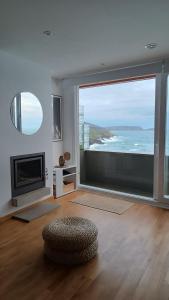 a living room with a large view of the ocean at Apartamento Sisargas in Malpica