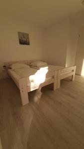 a large white bed in a room with lights on it at Herberhäuser Weinberge in Göttingen