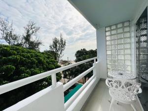 Un balcón con una silla blanca y vistas. en Bellagio Pets Friendly Resort, en Hong Kong