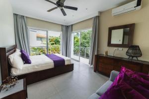 a bedroom with a bed and a mirror and a balcony at Luxury Private Villas with Pool, Private Beach, BBQ in Punta Cana