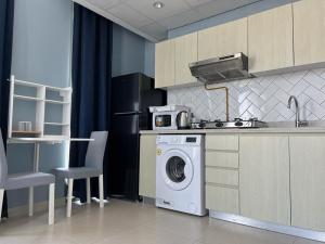 a kitchen with a washing machine and a sink at Cozy & Quiet Studio in Dubai