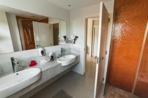 a bathroom with two sinks and a large mirror at Luxury Private Villas with Pool, Private Beach, BBQ in Punta Cana