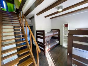 a room with a staircase and bunk beds at Das Hostel Rijeka in Rijeka