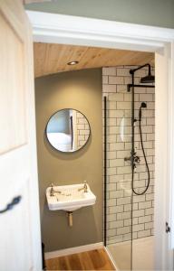 a bathroom with a sink and a mirror at Meadow View - Bottom Cabin in Foolow