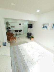 a living room with a bed and a living room with a couch at Habitación con entrada independiente in Vigo