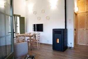 a living room with a wood stove and a table at Casa Rural Monte Zarro in Cudillero