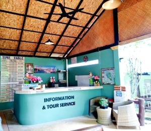 a restaurant with a counter and some chairs at Mild Garden View Resort in Ao Nang Beach