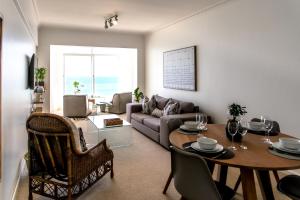 a living room with a table and a couch at Bayview 305A in Hermanus