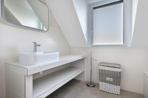 a white bathroom with a sink and a mirror at 300m de la plage - Grande terrasse - 8 personnes in Port Nayalo +22 photos