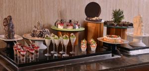 a display of cupcakes and desserts on a table at Holiday Inn Chandigarh Panchkula, an IHG Hotel in Chandīgarh