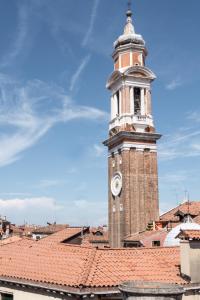 a tall clock tower on top of a roof at Venice Dream Apartments in Venice