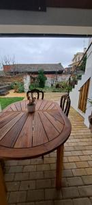 a wooden table and chairs on a patio at Casa da Avó do Puto in Mealhada