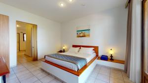 a bedroom with a large bed in a room at Acrotel Elea Beach in Elia