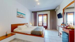 a hotel room with a bed and a kitchen at Acrotel Elea Beach in Elia