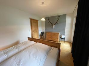 a bedroom with a bed and a dresser in it at Design Apartment Westendorf by Alpine Host Helpers in Westendorf