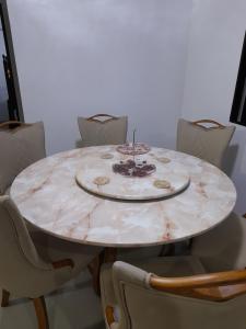 a white marble table with chairs around it at Silay DennisFhin Residence in Silay