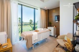 a hospital room with a bed and a window at AP Cabanas Beach & Nature - Adults Friendly in Cabanas de Tavira