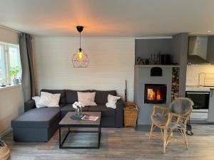 a living room with a couch and a fireplace at Lovely cottage in Bankeryd with a panoramic view of the lake in Bankeryd