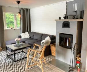 a living room with a couch and a fireplace at Lovely cottage in Bankeryd with a panoramic view of the lake in Bankeryd