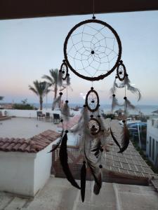 a dream catcher with birds on top of a roof at Farsha View in Sharm El Sheikh