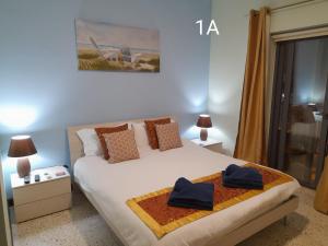 a bedroom with a bed with two towels on it at Seabreeze Guest Rooms in St Paul's Bay